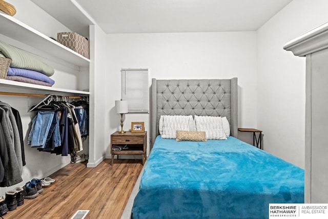 bedroom with a closet and hardwood / wood-style floors