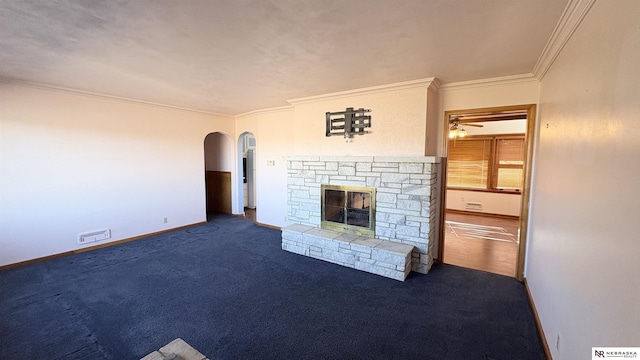 unfurnished living room featuring ornamental molding, a fireplace, and dark colored carpet