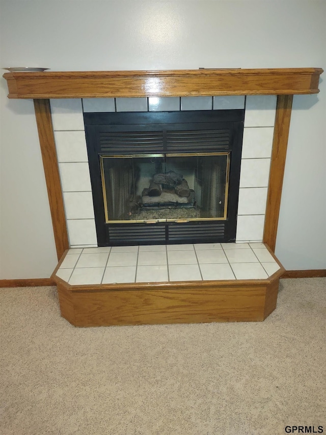 interior details featuring a fireplace and carpet