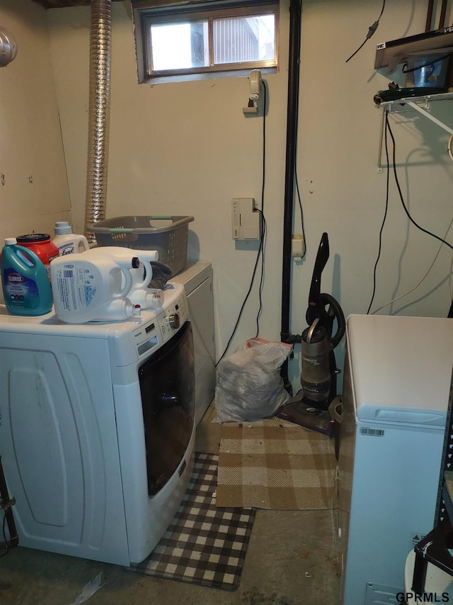 clothes washing area featuring washer and clothes dryer