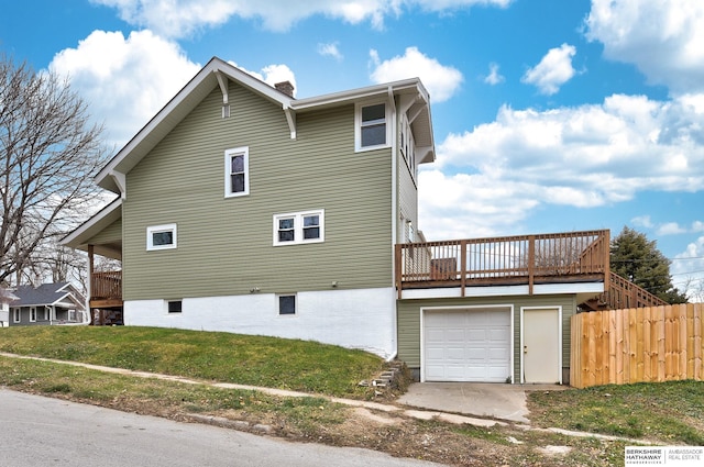 view of side of property featuring a yard and a garage