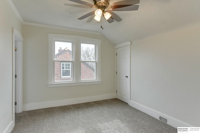 additional living space featuring a textured ceiling, carpet floors, ceiling fan, and lofted ceiling