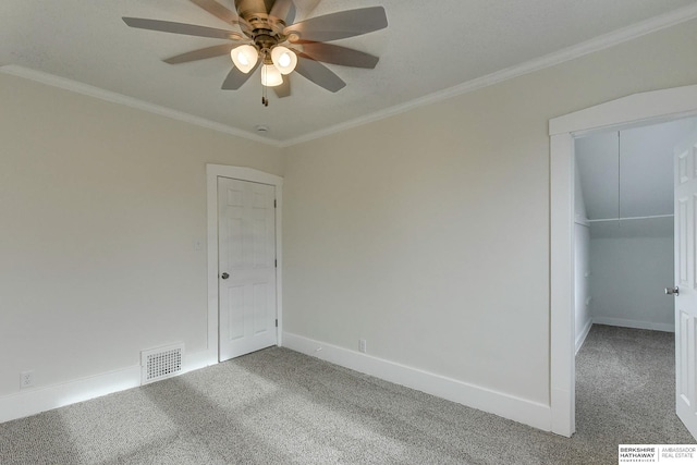 spare room with carpet, ceiling fan, and ornamental molding