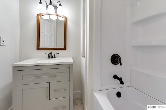 bathroom with bathtub / shower combination, vanity, and tile patterned flooring