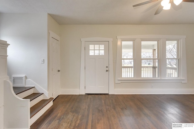 foyer entrance featuring ceiling fan and dark wood-type flooring