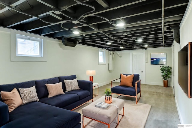 living room featuring electric panel and concrete flooring