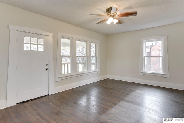 entrance foyer with ceiling fan, dark hardwood / wood-style flooring, and a textured ceiling