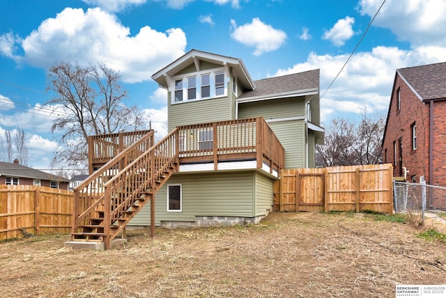 rear view of property featuring a deck