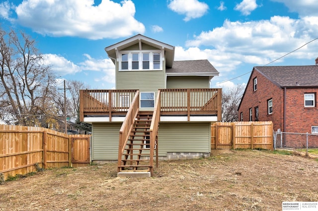 rear view of property featuring a deck