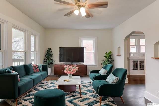 living room with ceiling fan and dark hardwood / wood-style floors