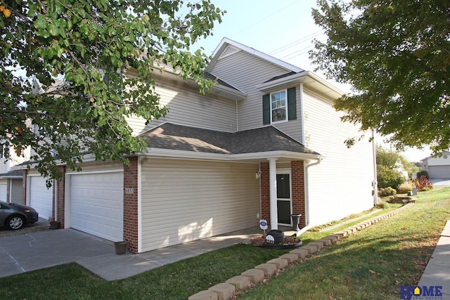 view of property featuring a garage and a front lawn