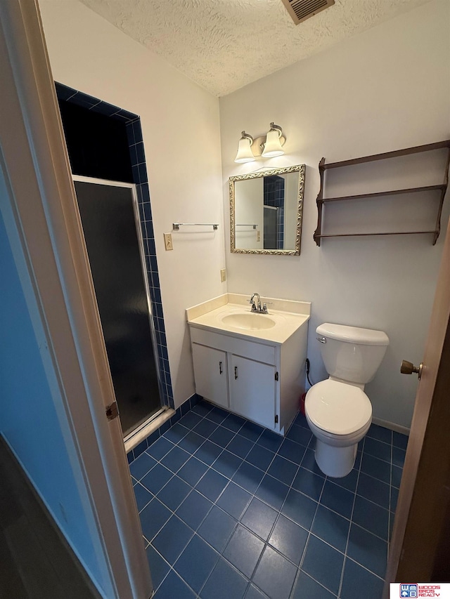 bathroom featuring toilet, tile patterned flooring, a textured ceiling, and walk in shower