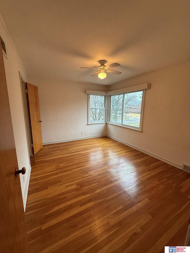 spare room featuring ceiling fan and hardwood / wood-style floors