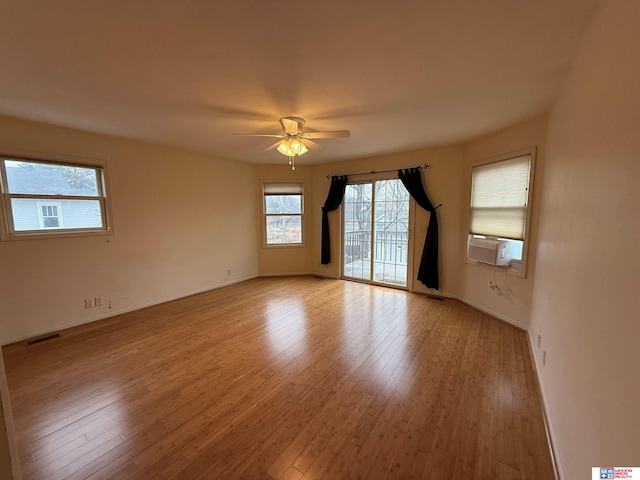 unfurnished room with ceiling fan, light hardwood / wood-style flooring, and cooling unit