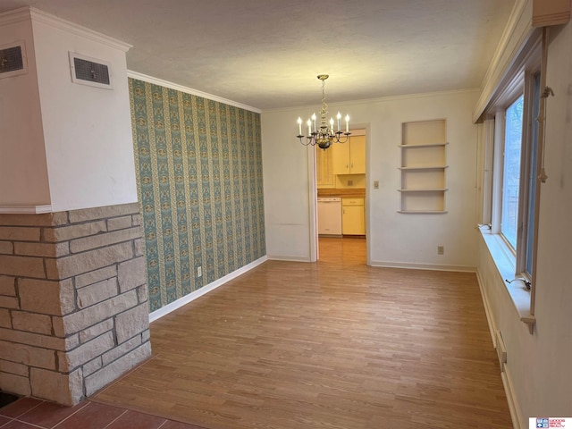 unfurnished dining area featuring hardwood / wood-style floors, built in features, ornamental molding, and a chandelier