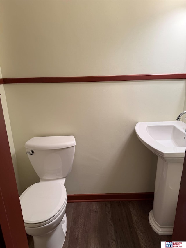 bathroom featuring hardwood / wood-style floors and toilet