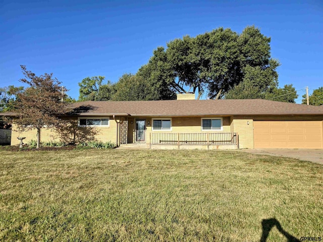 ranch-style home with a front yard and a garage