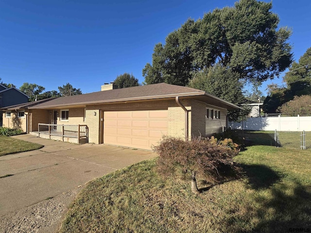 view of front facade with a garage and a front lawn