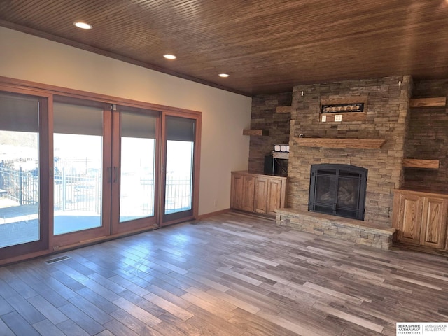 unfurnished living room featuring a fireplace, hardwood / wood-style floors, a wealth of natural light, and wood ceiling