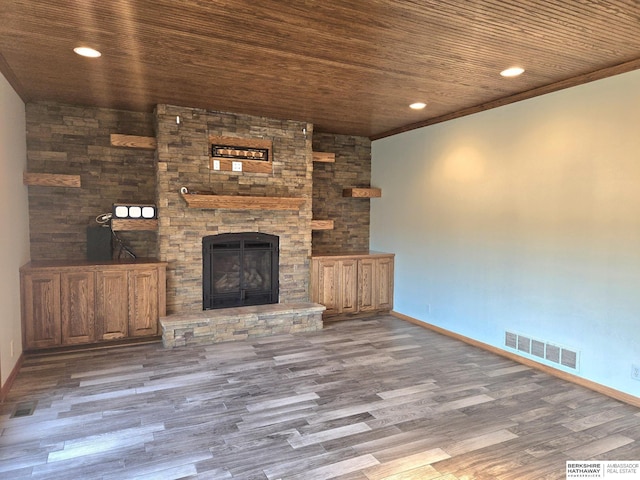 unfurnished living room with a fireplace, hardwood / wood-style flooring, and wooden ceiling