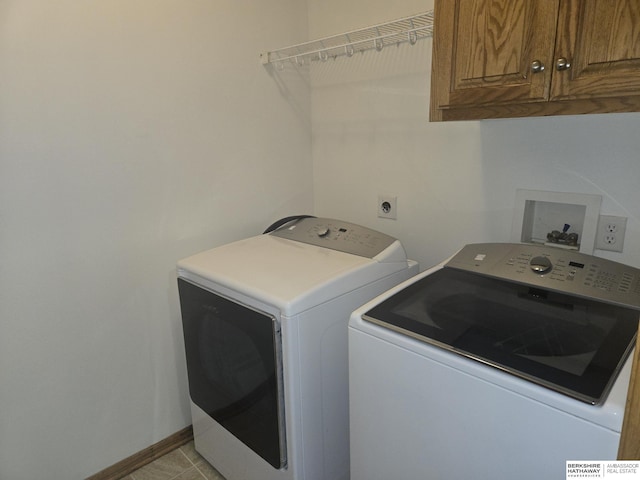 laundry area with cabinets and washing machine and dryer