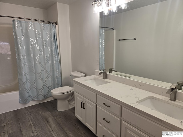 full bathroom featuring vanity, wood-type flooring, shower / bath combo, and toilet