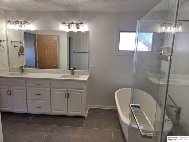 bathroom with tile patterned floors, vanity, separate shower and tub, and a textured ceiling