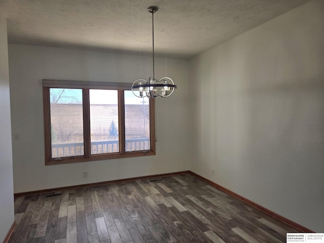 unfurnished dining area with a chandelier and dark hardwood / wood-style floors