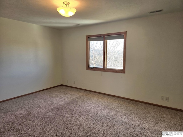 spare room featuring carpet