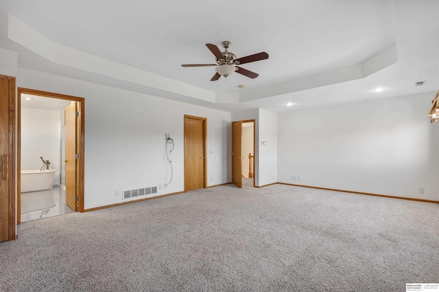 interior space featuring a tray ceiling and ceiling fan