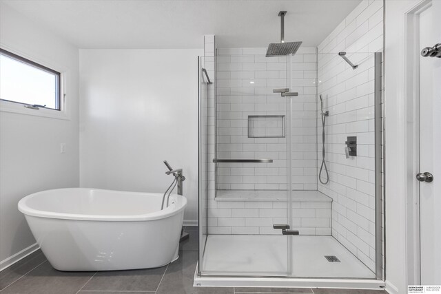 bathroom featuring tile patterned floors and independent shower and bath