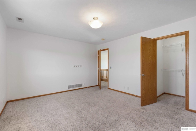 unfurnished bedroom with carpet floors and a closet