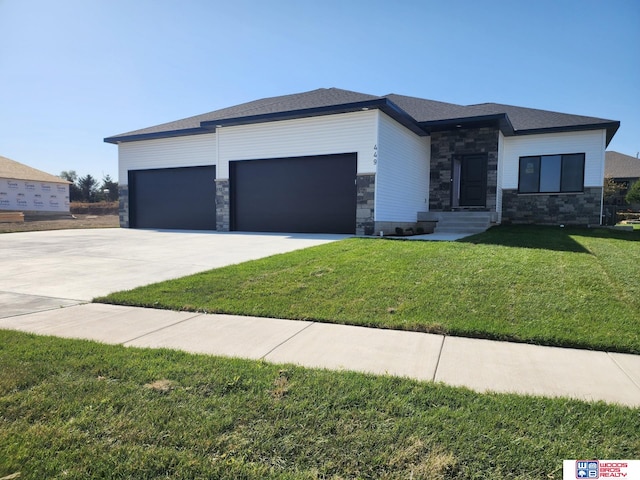 prairie-style home featuring a garage and a front yard