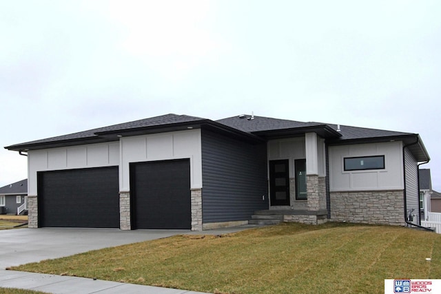 prairie-style home with a garage and a front lawn