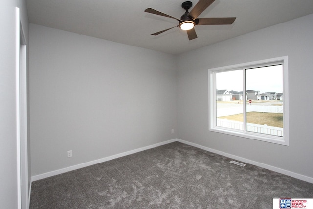 unfurnished room featuring dark carpet and ceiling fan