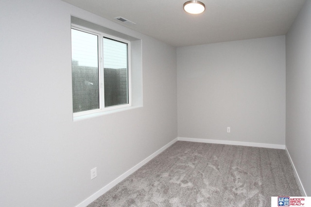 unfurnished room featuring light colored carpet