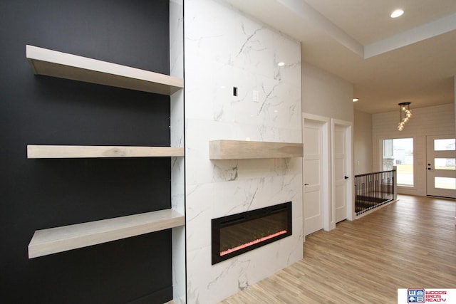 unfurnished living room featuring wood-type flooring and a premium fireplace