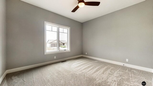 empty room featuring carpet flooring and ceiling fan