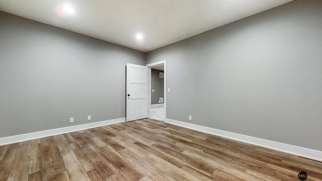 unfurnished room with light hardwood / wood-style floors