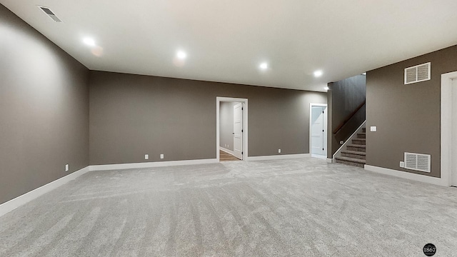 spare room featuring light colored carpet