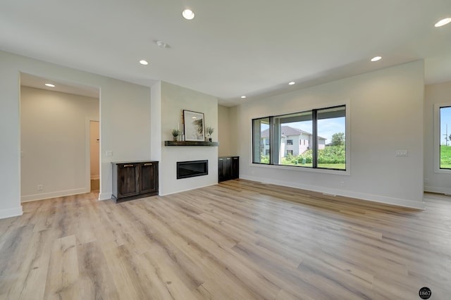 unfurnished living room featuring light hardwood / wood-style floors