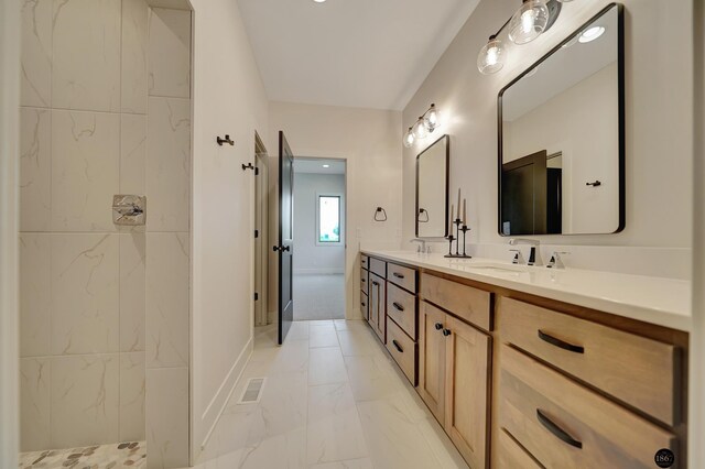 bathroom featuring a shower and vanity