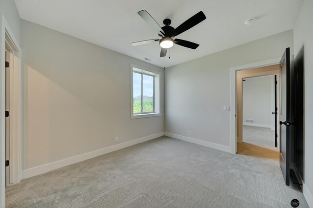 unfurnished bedroom with ceiling fan and light carpet