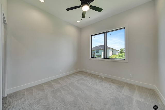 carpeted spare room featuring ceiling fan