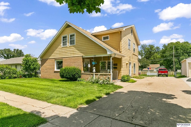 view of front of house with a porch and a front yard