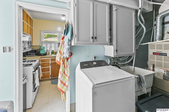 laundry area featuring cabinets and washer / dryer