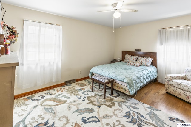 bedroom with ceiling fan and hardwood / wood-style floors