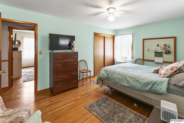 bedroom with light hardwood / wood-style floors and ceiling fan