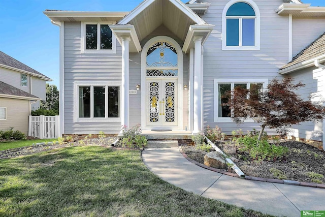 doorway to property with a yard