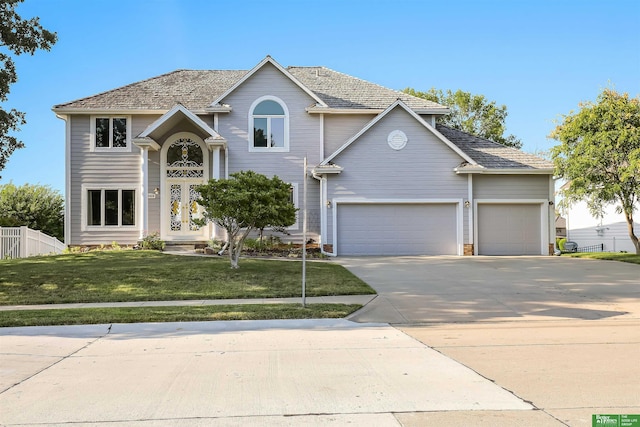 view of front of home featuring a front lawn and a garage